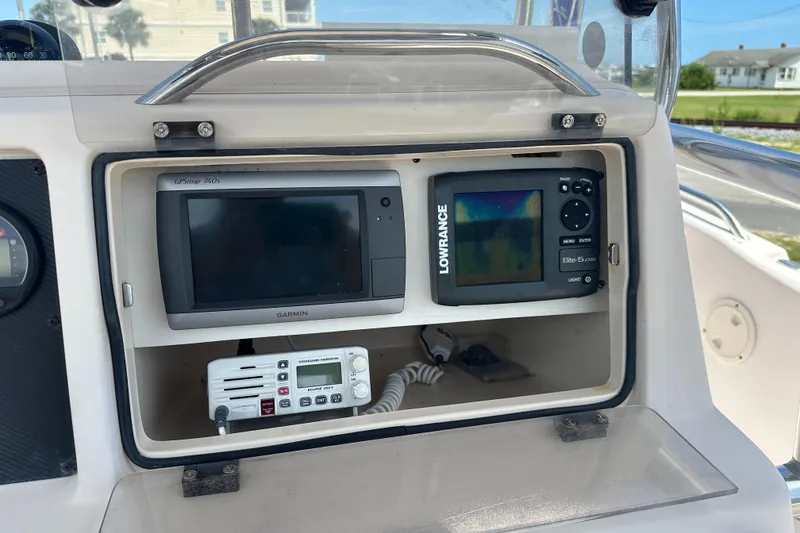 Slide: The Image of Dashboard of a 2005 Grady-White Escape 209 with Garmin and Lowrance navigation systems. - 27