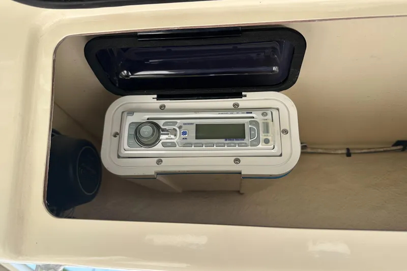 Slide: The Image of 2005 Grady-White Escape 209 boat stereo system in protective compartment. - 28