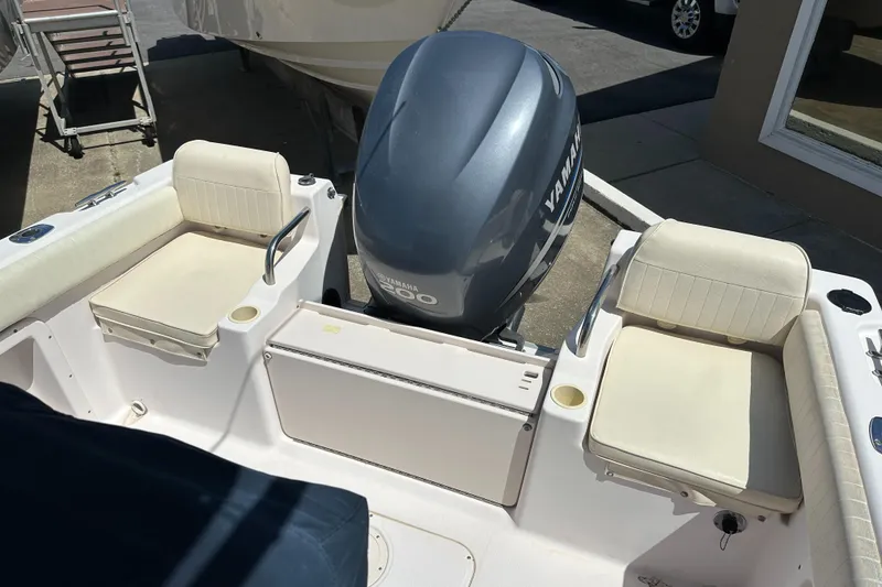 Slide: The Image of 2005 Grady-White Escape 209 boat interior with Yamaha engine and cushioned seating. - 32