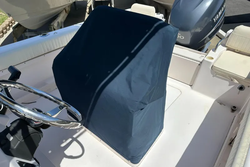 Slide: The Image of 2005 Grady-White Escape 209 boat interior with covered console and Yamaha engine. - 34