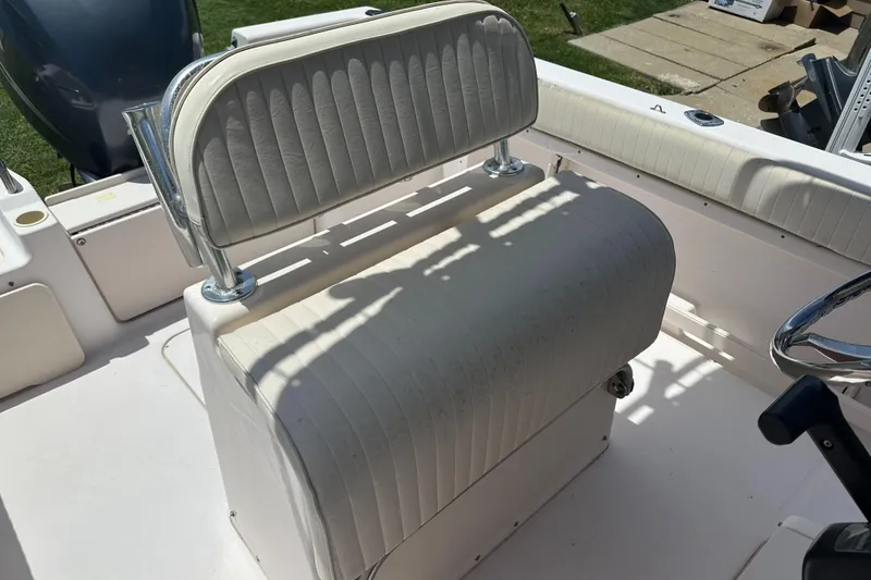 Slide: The Image of 2005 Grady-White Escape 209 boat seat with white upholstery and chrome accents. - 35