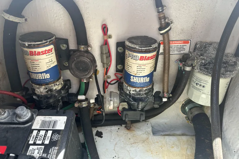 Slide: The Image of Electrical and plumbing components inside a 2005 Grady-White Escape 209 boat. - 39