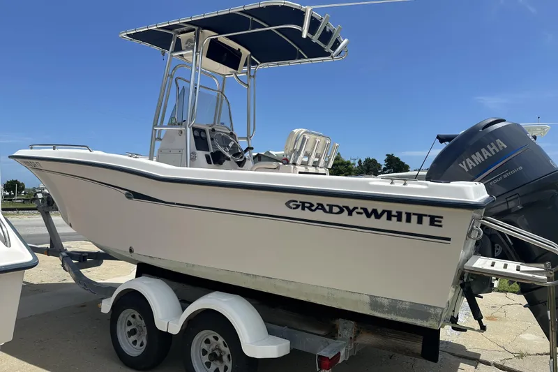 Slide: The Image of 2005 Grady-White Escape 209 boat on trailer with Yamaha engine, under clear blue sky. - 5