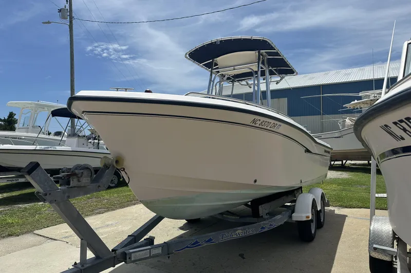 Slide: The Image of 2005 Grady-White Escape 209 boat on trailer, parked outdoors under clear sky. - 6