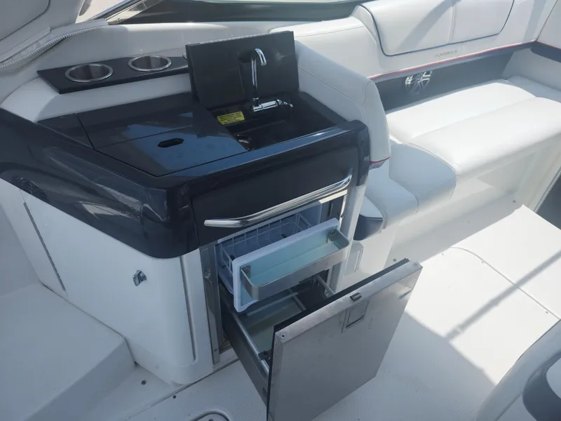 Slide: The Image of 2020 Formula 310 Sun Sport boat interior with sink and open mini fridge. - 10