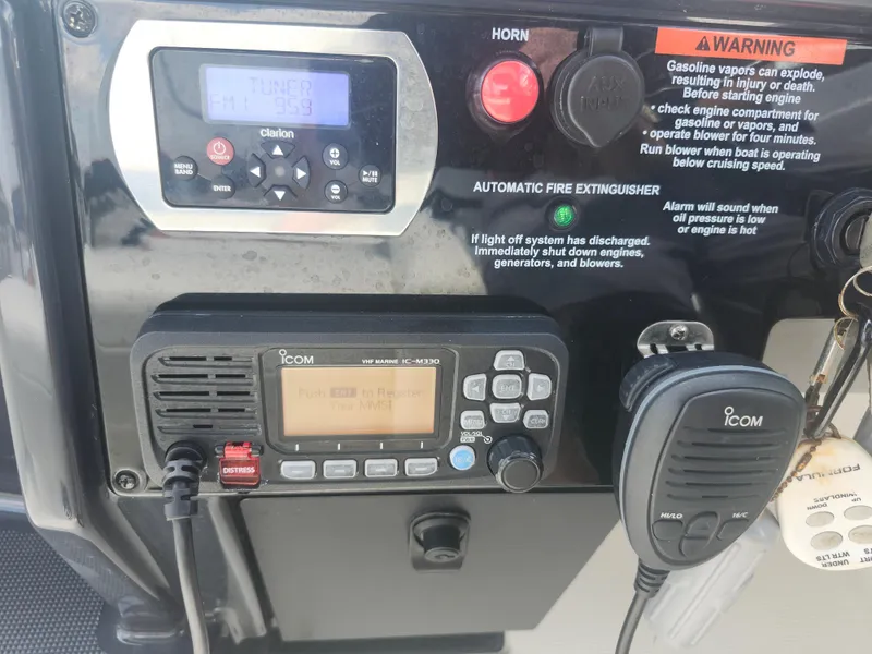 Slide: The Image of Control panel of a 2020 Formula 310 Sun Sport with radio and safety warnings. - 18