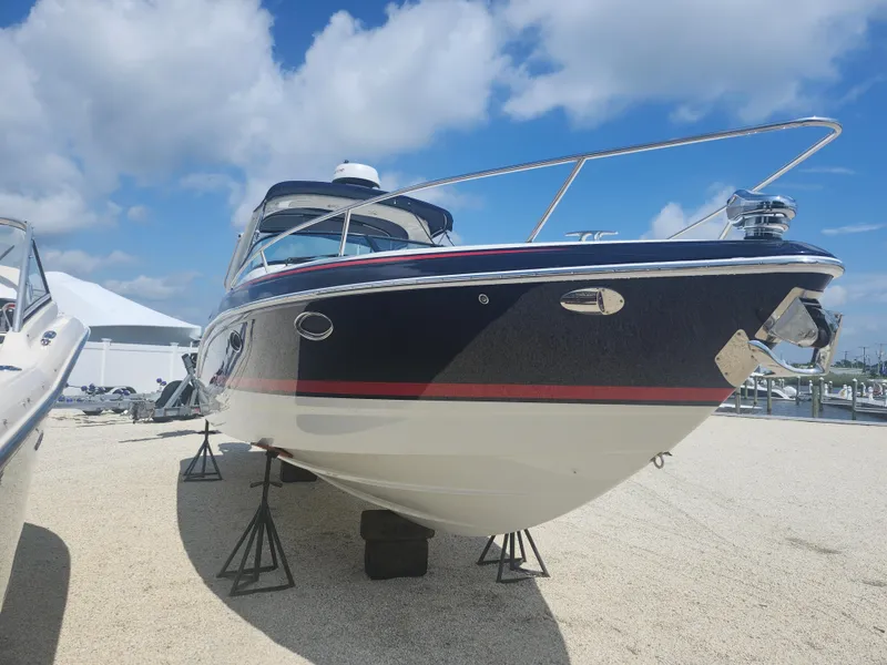 Slide: The Image of 2020 Formula 310 Sun Sport boat on stands, clear sky background. - 2