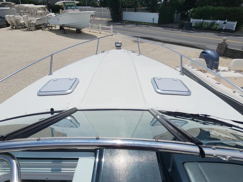 Slide: The Image of 2020 Formula 310 Sun Sport boat deck view at a marina. - 26