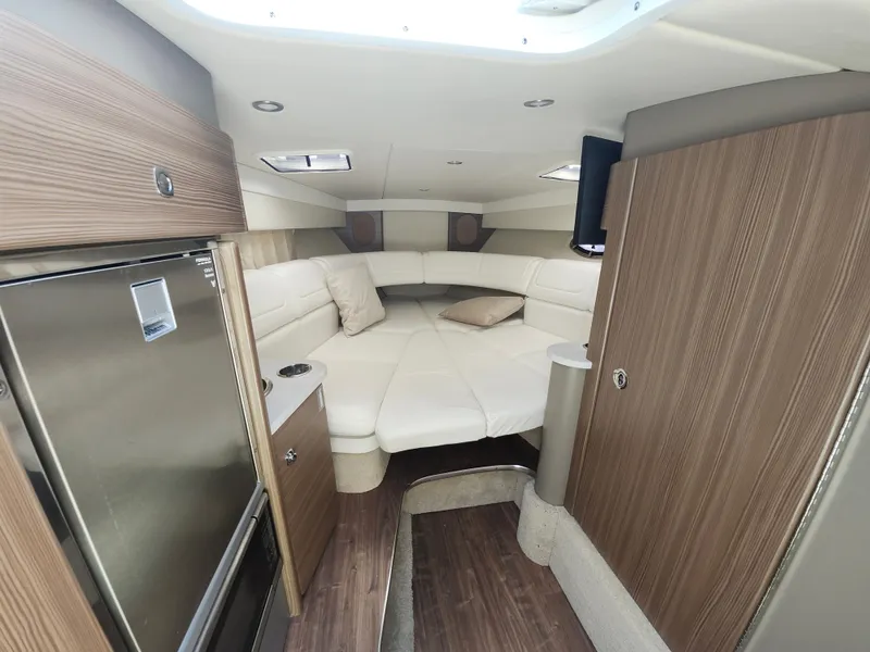 Slide: The Image of 2020 Formula 310 Sun Sport cabin interior with modern wood finish and cozy seating area. - 28