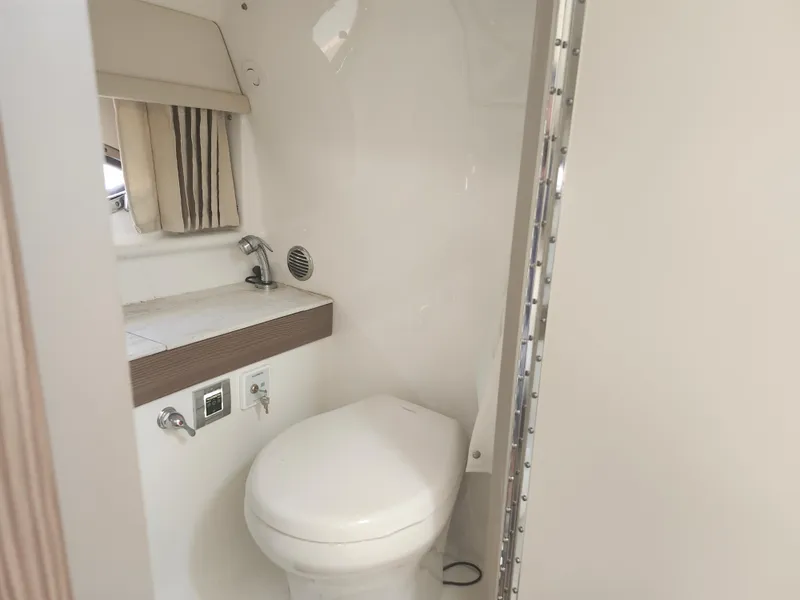 Slide: The Image of 2020 Formula 310 Sun Sport boat bathroom with toilet and sink. - 31