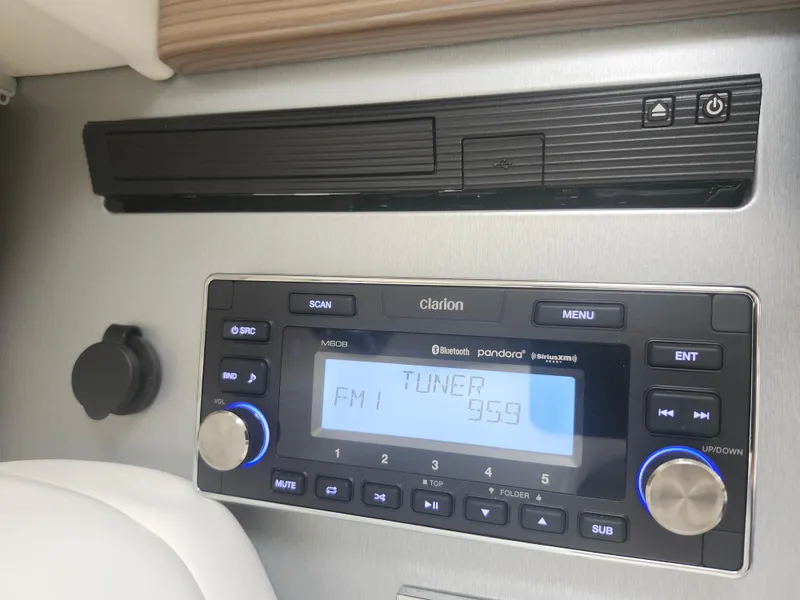 Slide: The Image of Clarion audio system in 2020 Formula 310 Sun Sport boat, displaying FM tuner at 95.9. - 32