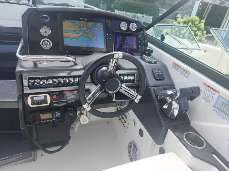 Slide: The Image of 2020 Formula 310 Sun Sport boat dashboard with steering wheel and navigation system. - 4