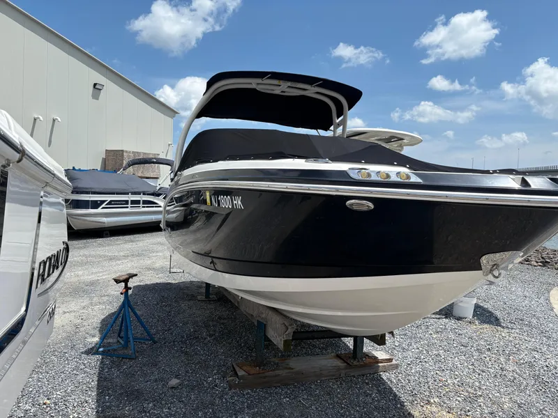 Slide: The Image of 2016 Chaparral 230 Suncoast boat on display, parked outdoors under a clear sky. - 14