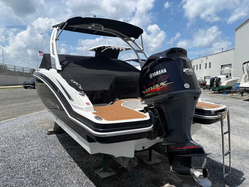 Slide: The Image of 2016 Chaparral 230 Suncoast boat with Yamaha VMAX 250 engine, parked outdoors. - 15