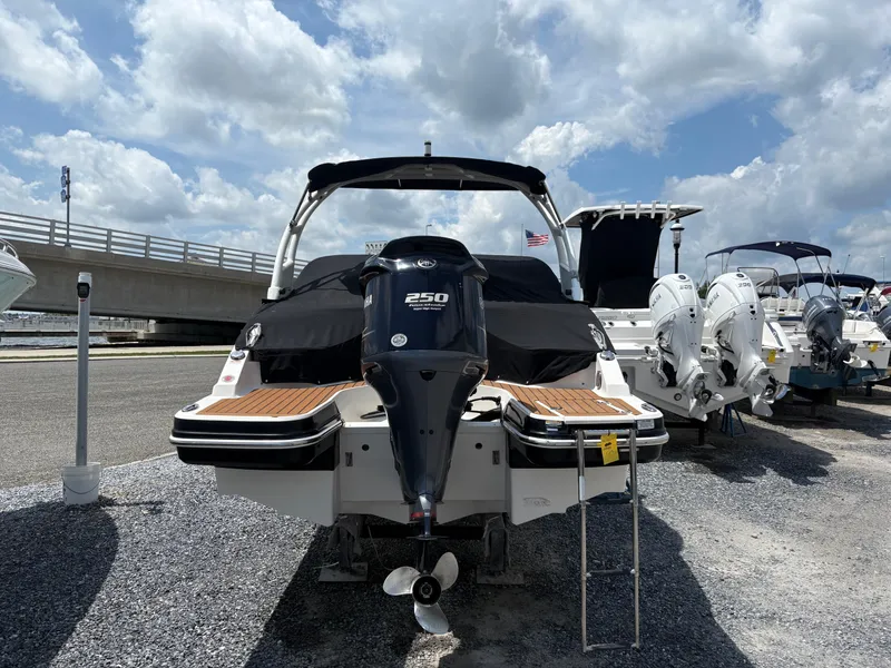 Slide: The Image of 2016 Chaparral 230 Suncoast boat with Yamaha 250 engine, docked under cloudy sky. - 16