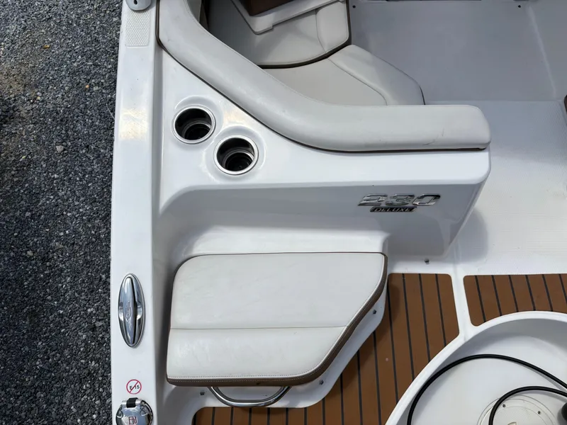 Slide: The Image of 2016 Chaparral 230 Suncoast boat interior with seating and cup holders. - 17