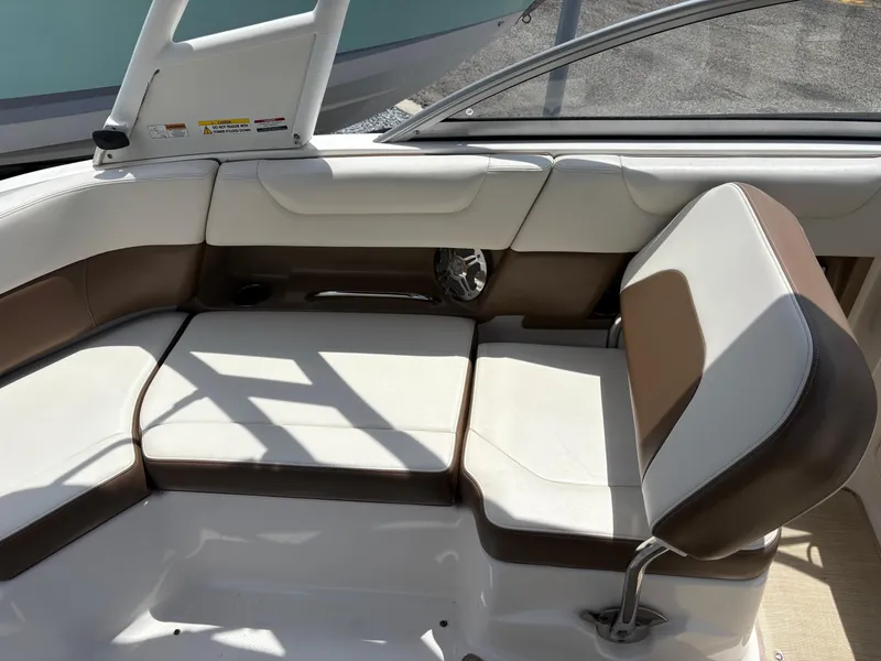 Slide: The Image of 2016 Chaparral 230 Suncoast boat interior with white and brown seating. - 21