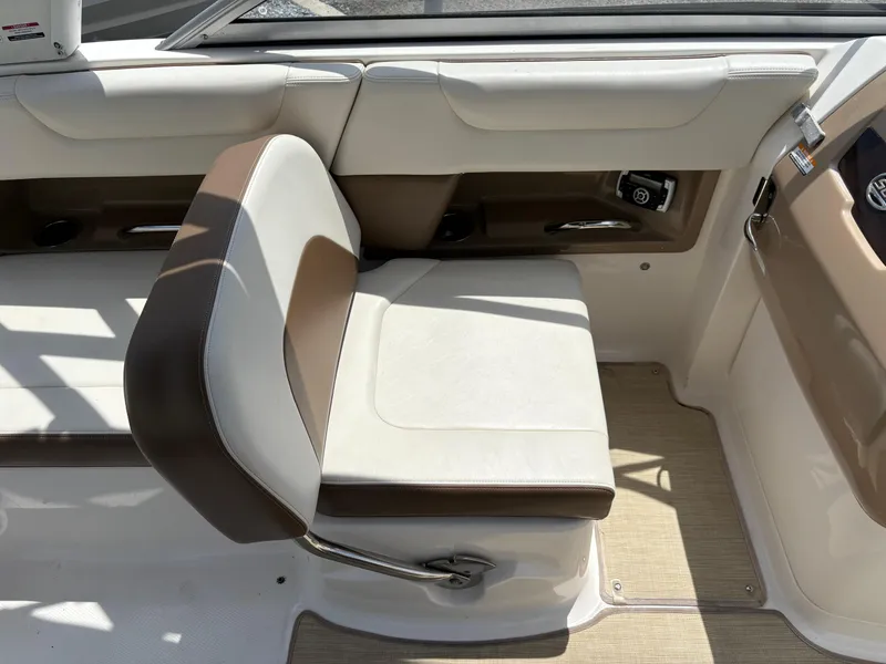 Slide: The Image of 2016 Chaparral 230 Suncoast boat interior with beige and brown seating. - 22