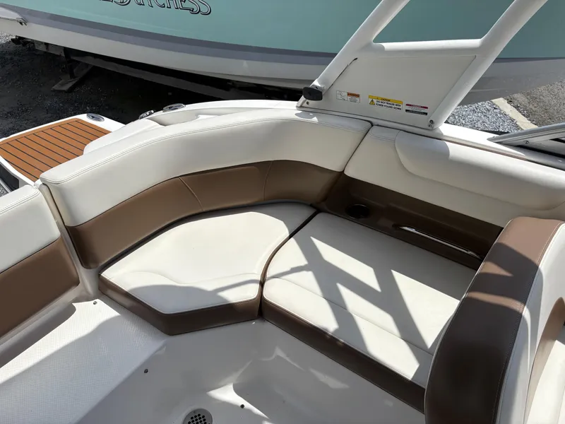 Slide: The Image of 2016 Chaparral 230 Suncoast boat interior with brown and white seating. - 23