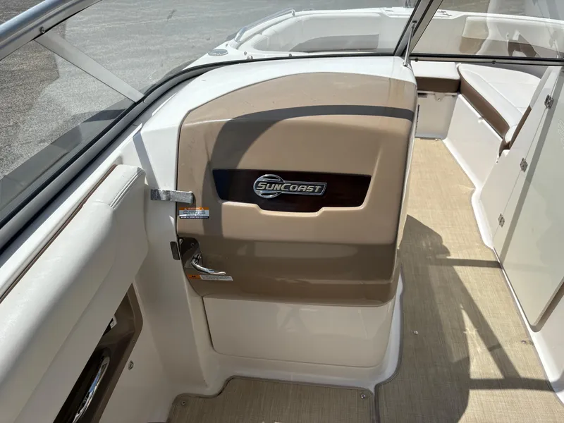Slide: The Image of 2016 Chaparral 230 Suncoast boat interior with Suncoast logo and seating area. - 27