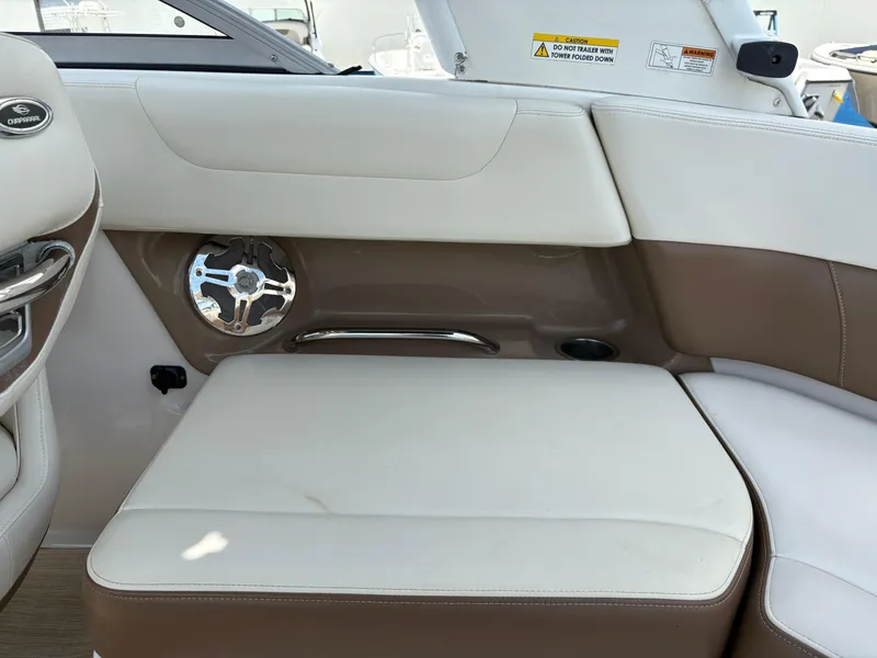 Slide: The Image of 2016 Chaparral 230 Suncoast boat interior with cushioned seating and speaker. - 28