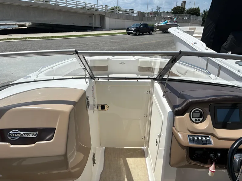 Slide: The Image of 2016 Chaparral 230 Suncoast boat interior with dashboard and seating area. - 31