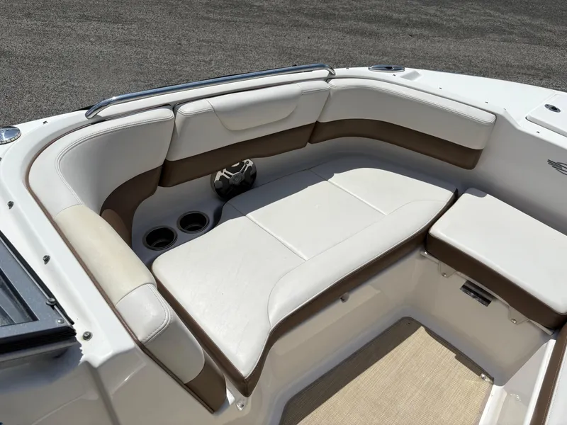 Slide: The Image of 2016 Chaparral 230 Suncoast boat interior with white and brown seating. - 33
