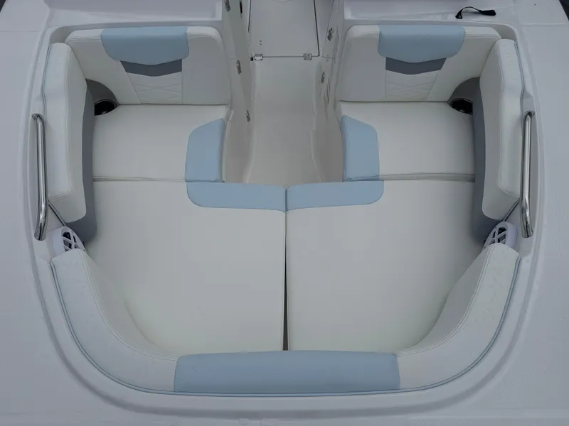 Slide: The Image of 2025 Robalo R207 Dual Console boat seating, featuring white and light blue cushioned seats. - 10