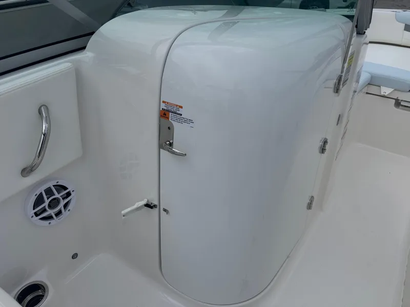 Slide: The Image of 2025 Robalo R207 Dual Console interior with storage compartment and speaker. - 12