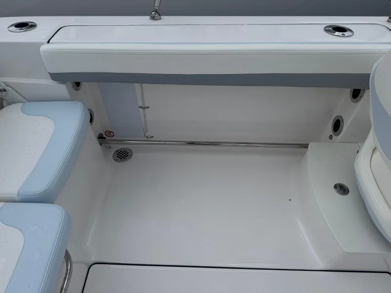 Slide: The Image of 2025 Robalo R207 Dual Console boat interior with white and blue seating. - 14