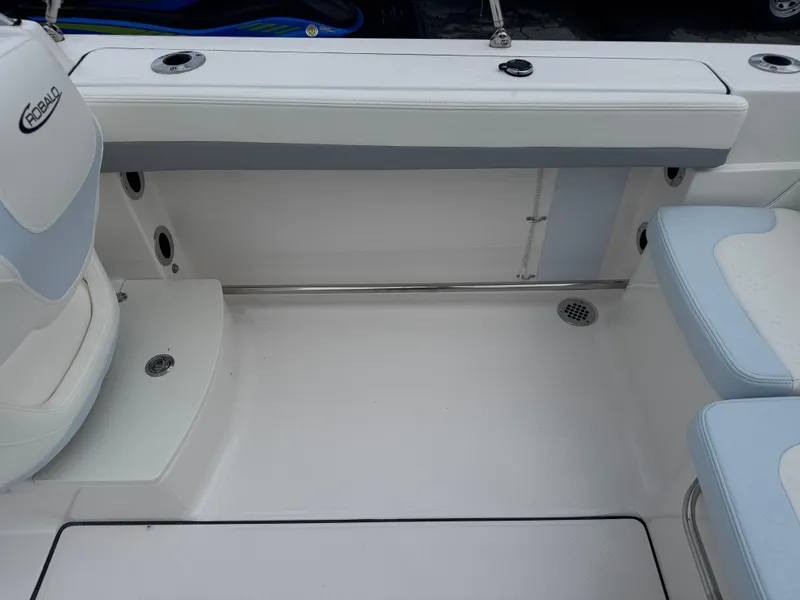Slide: The Image of 2025 Robalo R207 Dual Console boat interior with white and blue seating. - 16
