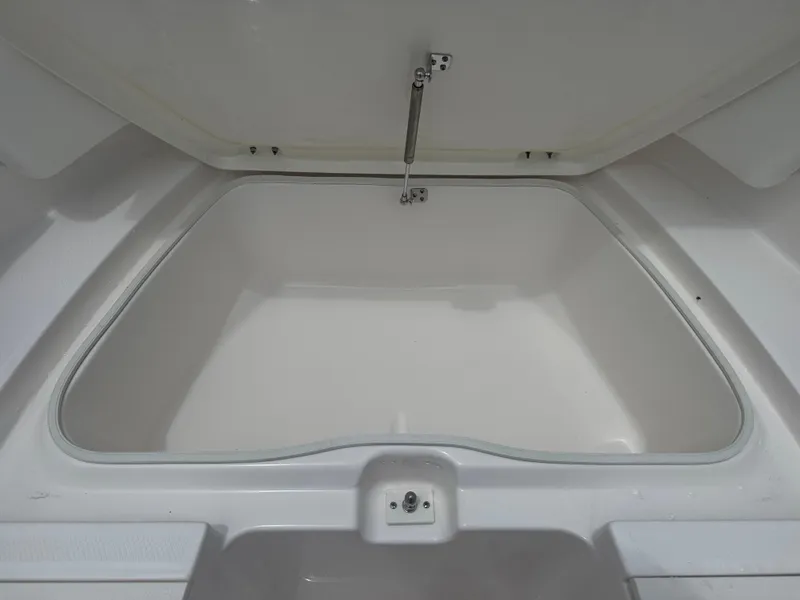 Slide: The Image of Open storage compartment in 2025 Robalo R207 Dual Console boat. - 21