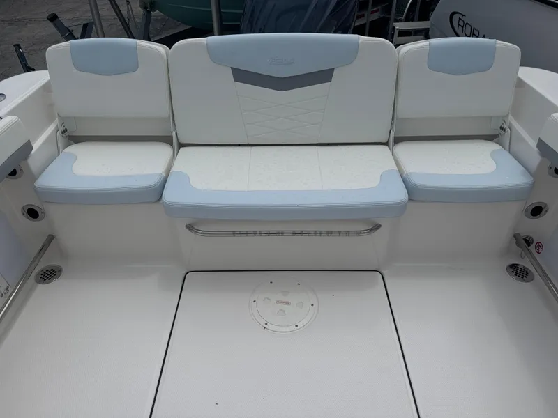 Slide: The Image of 2025 Robalo R207 Dual Console boat seating area with white and light blue cushions. - 25