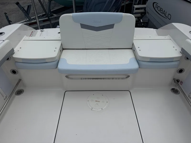 Slide: The Image of 2025 Robalo R207 Dual Console boat interior with cushioned seating and storage compartments. - 26