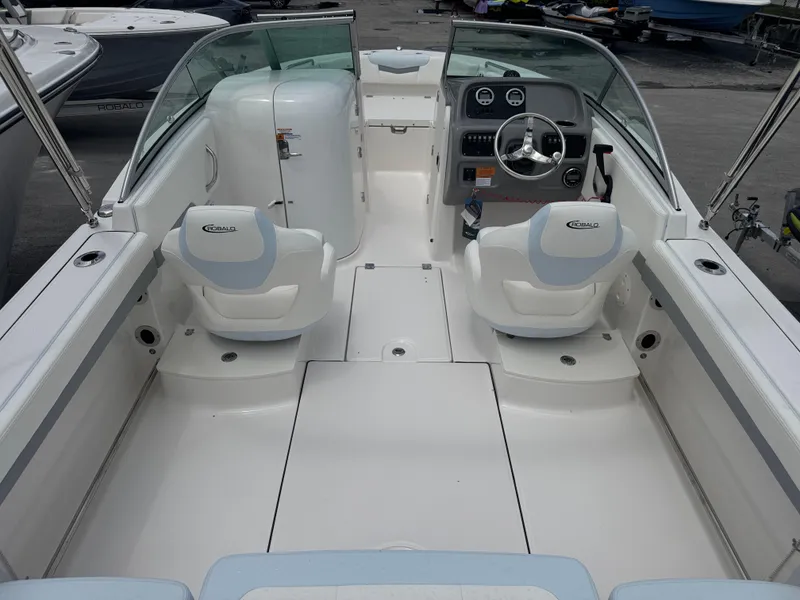 Slide: The Image of 2025 Robalo R207 Dual Console boat interior with steering wheel and seating. - 4