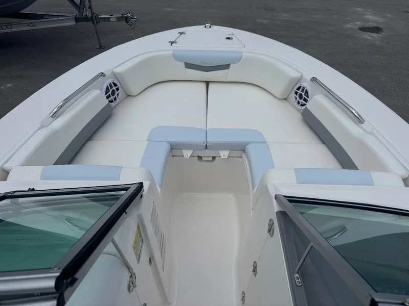 Slide: The Image of 2025 Robalo R207 Dual Console boat interior with cushioned seating and speakers. - 6