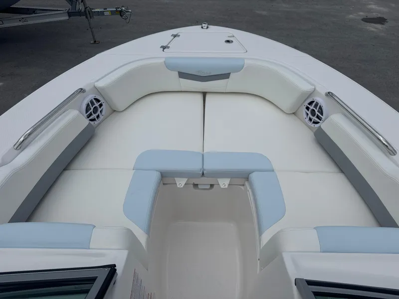 Slide: The Image of 2025 Robalo R207 Dual Console boat interior with cushioned seating and speakers. - 7