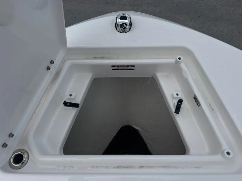 Slide: The Image of Open storage compartment on 2025 Robalo R207 Dual Console boat. - 9