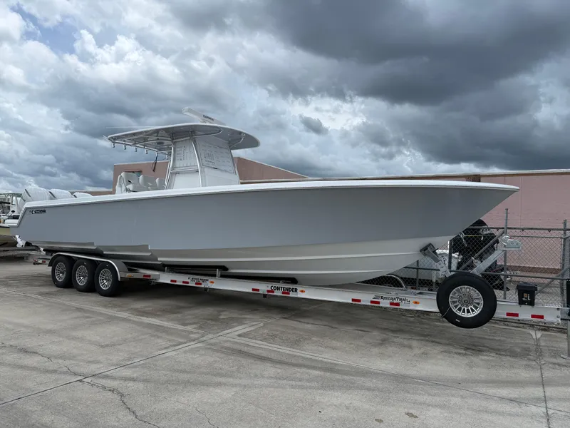 The Image of 2026 Contender 39 ST boat on trailer under cloudy sky. - 1