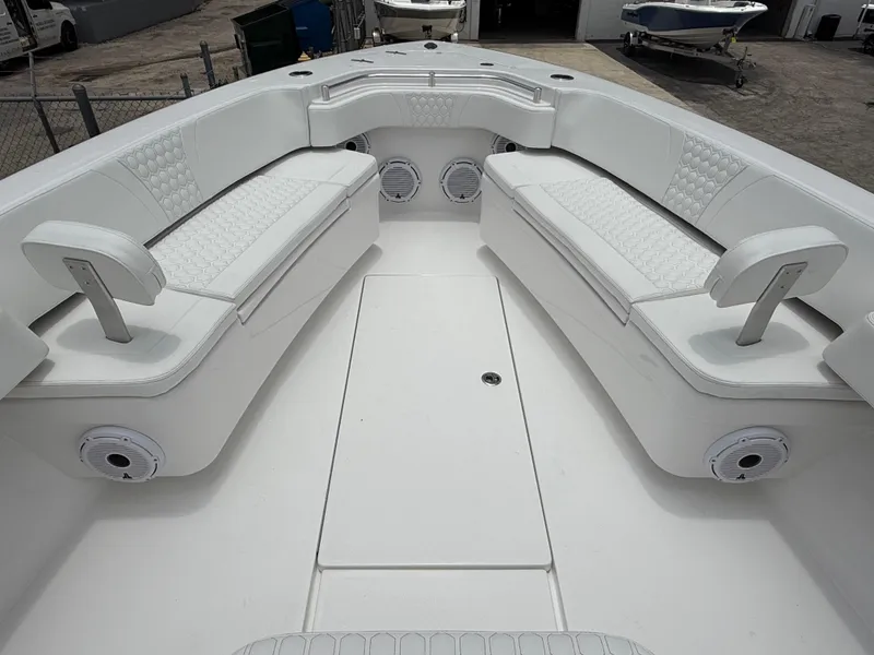 Slide: The Image of 2026 Contender 39 ST boat interior with white cushioned seating and speakers. - 16