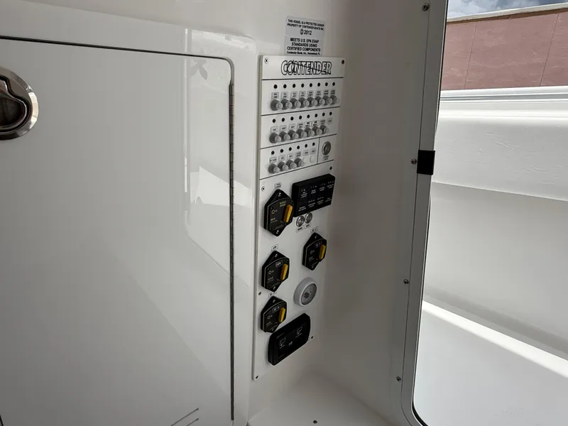 Slide: The Image of Control panel of 2026 Contender 39 ST boat, featuring switches and dials. - 18