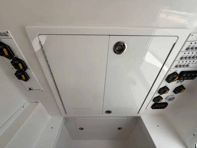 Slide: The Image of 2026 Contender 39 ST boat control panel with switches and storage compartment. - 20