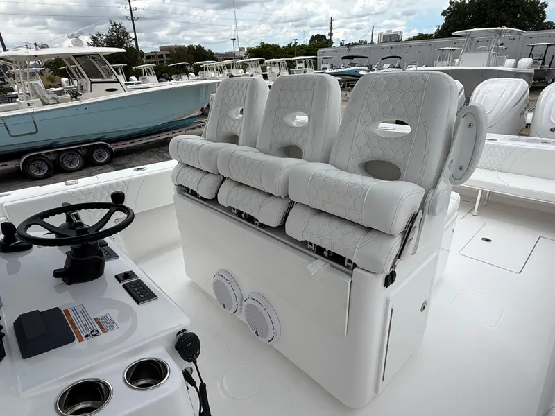 Slide: The Image of 2026 Contender 39 ST boat interior with white cushioned seats and steering console. - 23