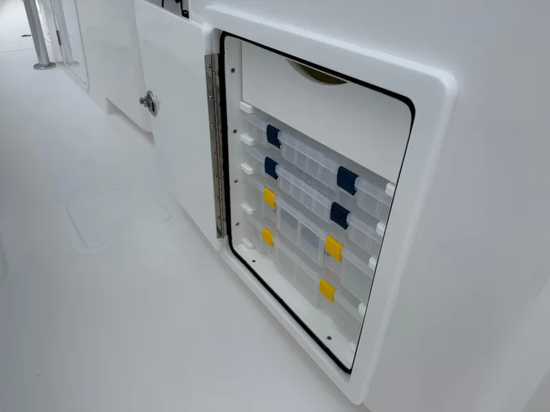 Slide: The Image of Storage compartment with organized tackle boxes on a 2026 Contender 39 ST boat. - 24