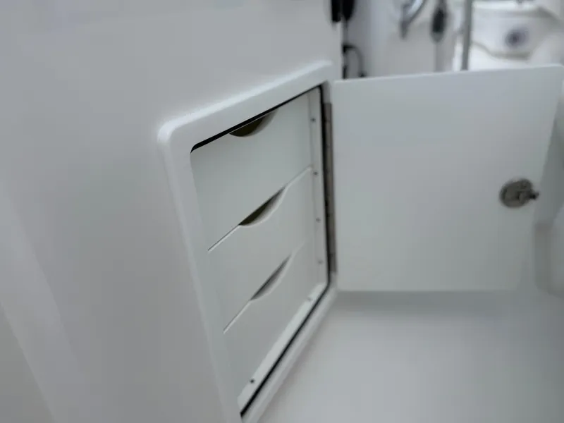 Slide: The Image of Open storage compartment with drawers on a 2026 Contender 39 ST boat. - 25