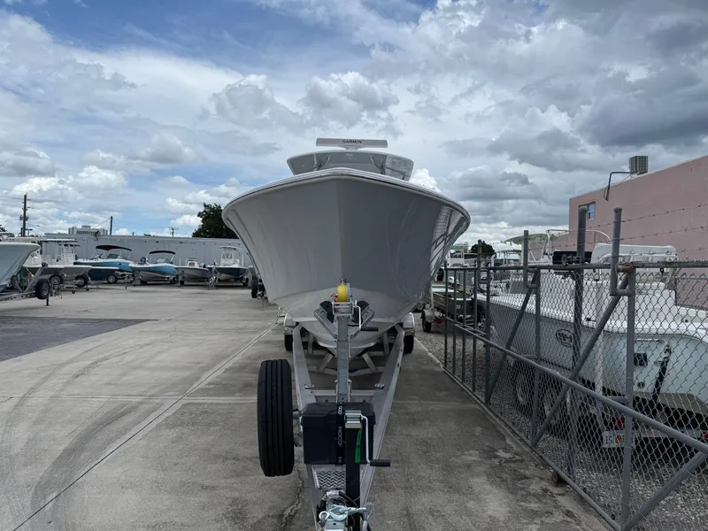 Slide: The Image of 2026 Contender 39 ST boat on trailer in a marina under cloudy sky. - 26