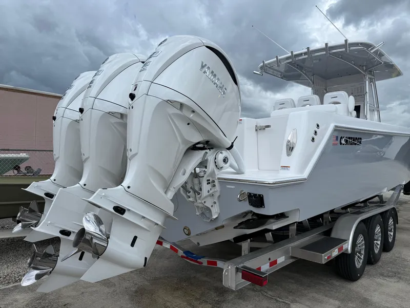 Slide: The Image of 2026 Contender 39 ST boat with triple outboard engines on a trailer. - 4