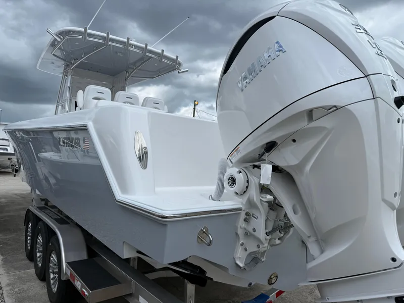 Slide: The Image of 2026 Contender 39 ST boat with Yamaha engine, parked on a trailer under cloudy skies. - 6