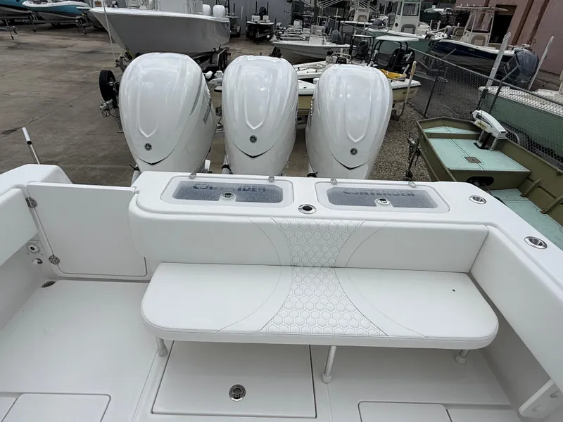 Slide: The Image of 2026 Contender 39 ST boat with triple outboard engines, white seating, and fishing deck. - 7