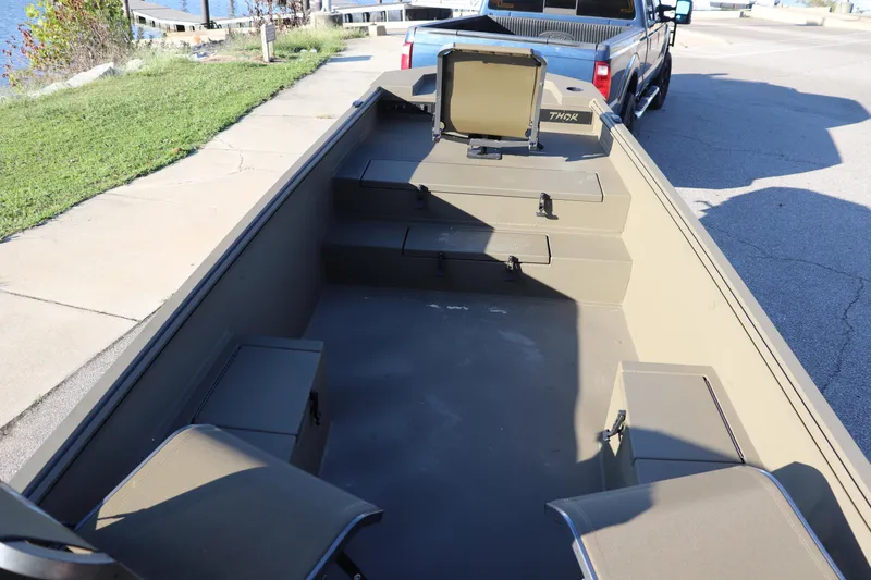 Slide: The Image of 2025 Thor 1754 Lake Hammer Tiller boat interior with seating and storage compartments. - 6